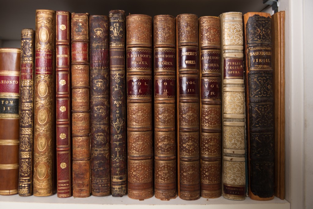 Rare books that are very old but in excellent condition. All are variationsof deep maroon and gold leather binding.